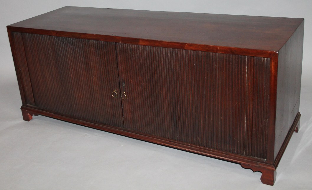 Appraisal: A thC polished mahogany side cabinet with tambour fronts revealing