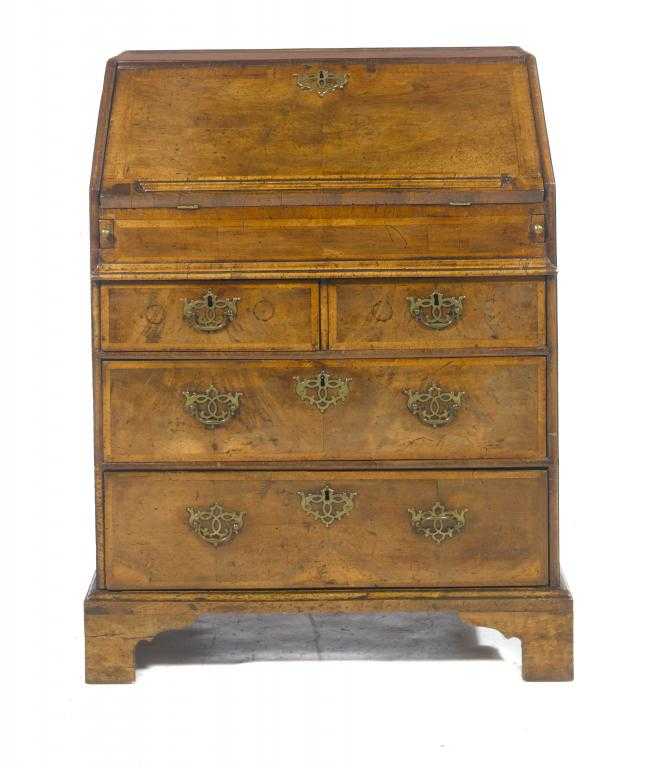 Appraisal: A QUEEN ANNE WALNUT AND FEATHER BANDED BUREAU the fitted