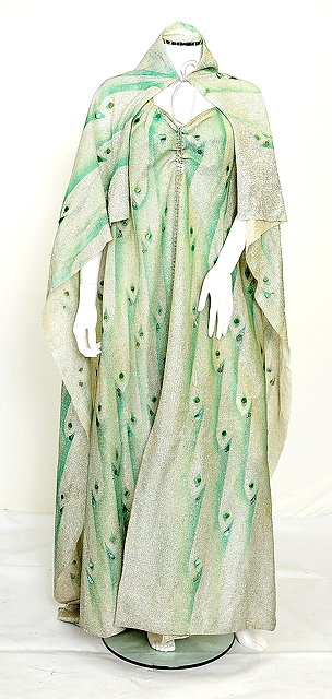 Appraisal: A green tone coloured lam dress and matching cloak worn