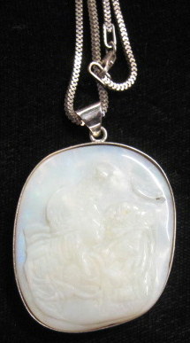 Appraisal: Sterling silver carved opal pendantDisplaying two Classical figures in profile