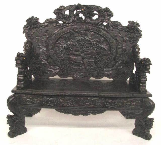 Appraisal: A heavily carved Oriental settee depicting dragons birds and flowers