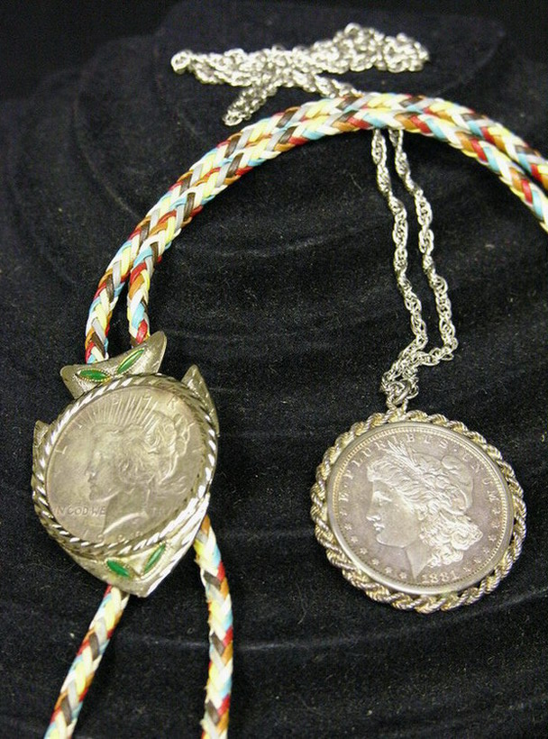 Appraisal: TWO U S SILVER DOLLAR NECKLACES Bolo has Peace Necklace