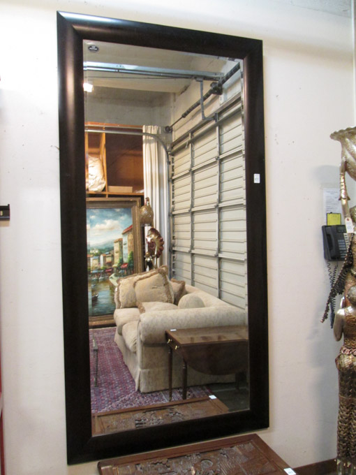 Appraisal: LARGE WALL MIRROR a rectangular beveled mirror in dark hardwood