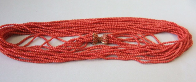 Appraisal: An eight strand coral bead long necklace on a coral