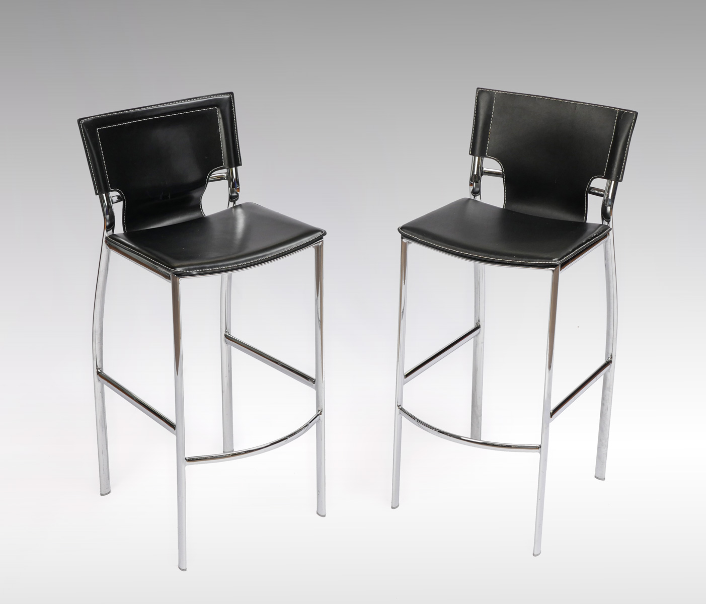 Appraisal: PAIR OF MODERN CHROME BAR STOOLS Black faux leather upholstered