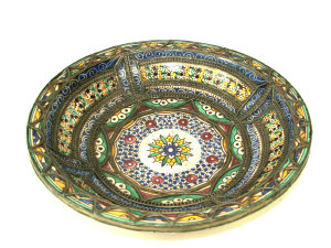 Appraisal: A Moroccan circular pottery charger with floral decoration and applied