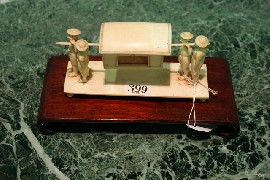 Appraisal: An ivory figural group of a palanquin carried by four