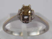 Appraisal: A white metal tests carat gold brown diamond solitaire ring