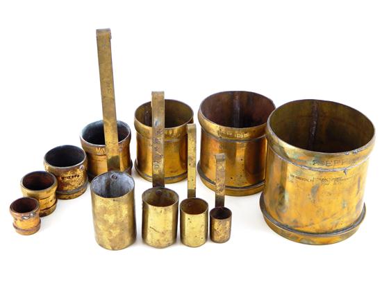 Appraisal: ASIAN Indian brass measures eleven pieces seven graduated canisters Seer