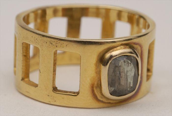 Appraisal: GOLD CUT-OUT BAND WITH FACETED GREEN STONE Approx size Provenance