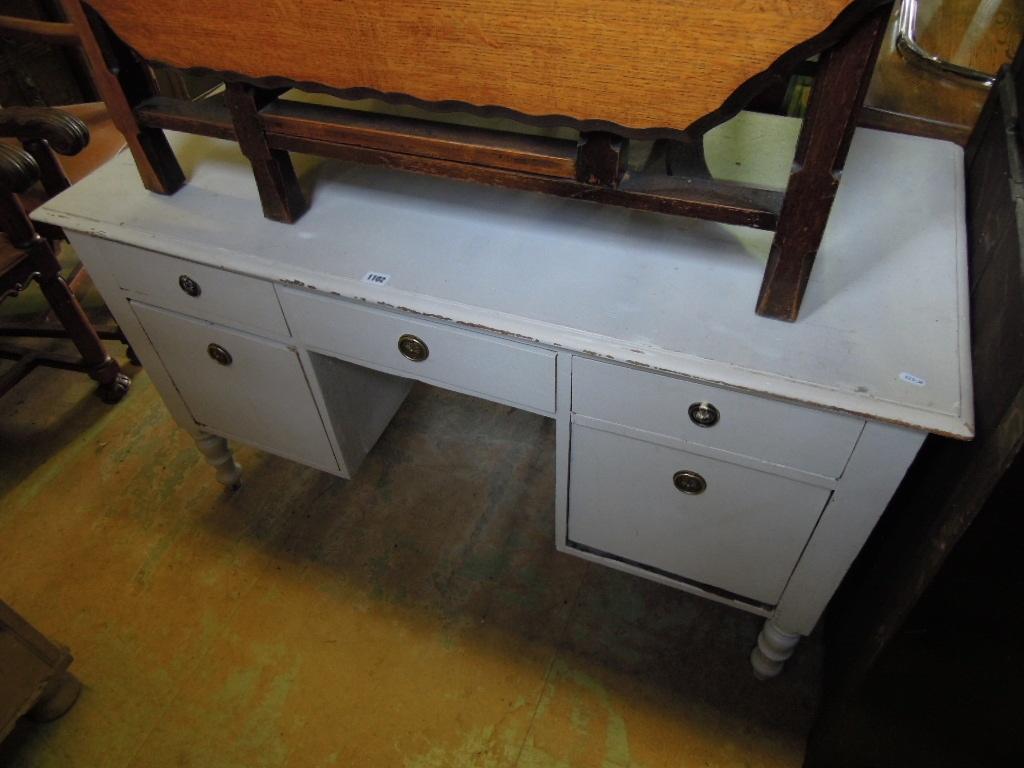 Appraisal: A kneehole dressing table fitted with an arrangement of five