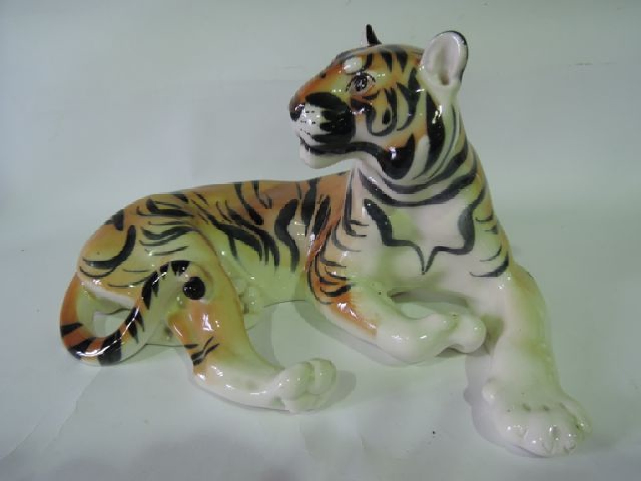 Appraisal: A large model of a recumbent tiger with faint mark