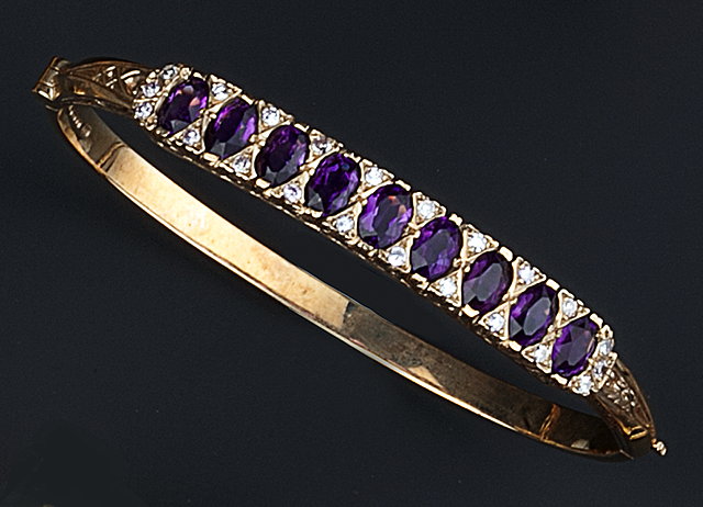 Appraisal: AN AMETHYST AND DIAMOND SET BANGLE of hinged oval form