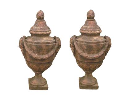 Appraisal: Pair of Classical cast-metal covered urnsWith a pineapple finial to