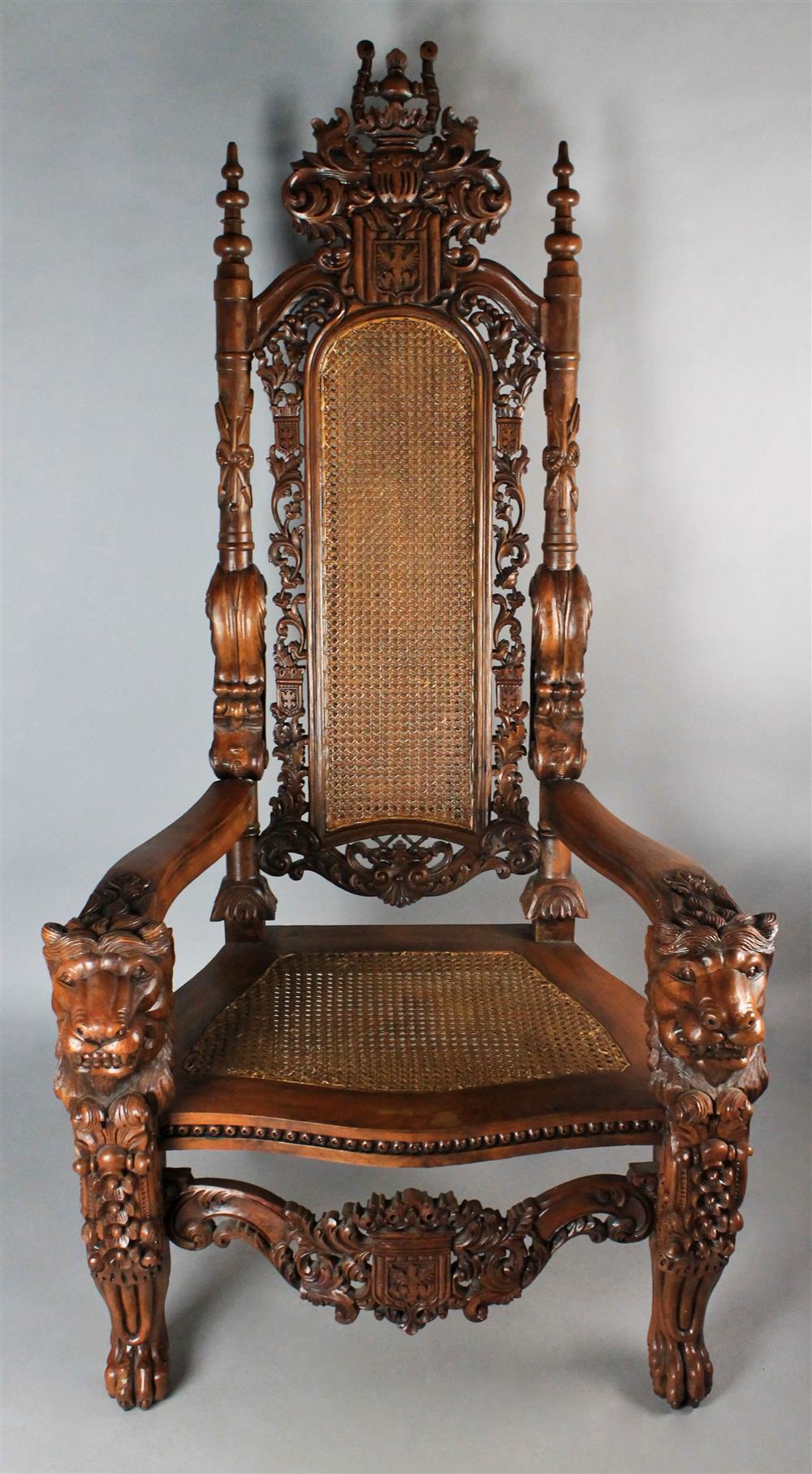 Appraisal: RENAISSANCE REVIVAL CARVED WALNUT AND CANE THRONE CHAIR having a