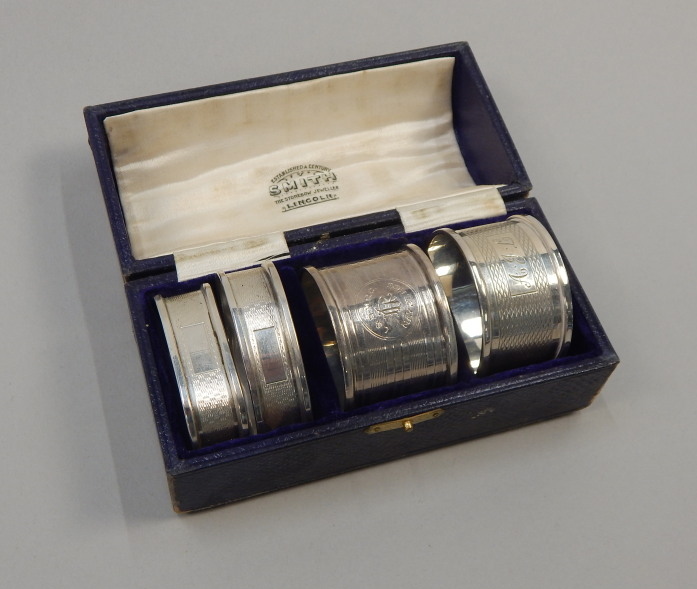 Appraisal: Four engine turned silver napkin rings each of different design