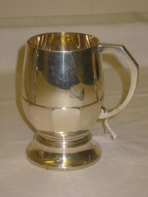 Appraisal: A TANKARD of half panelled bellied form with faceted loop