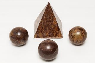 Appraisal: Marble Ornaments Brown with elaborate multicolored inclusions Pyramid H spheres