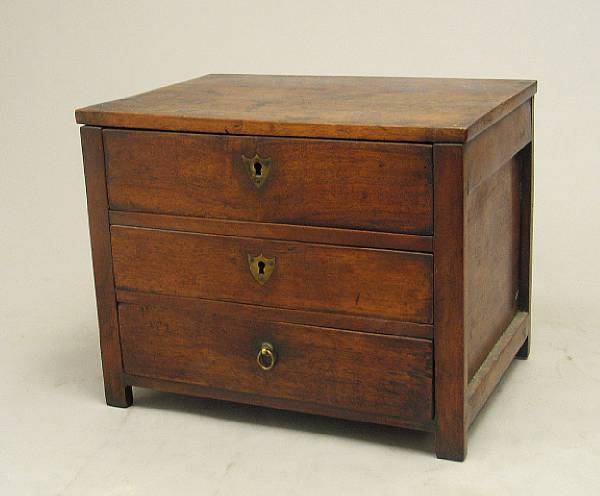 Appraisal: A Continental walnut miniature chest th century Of rectangular outline