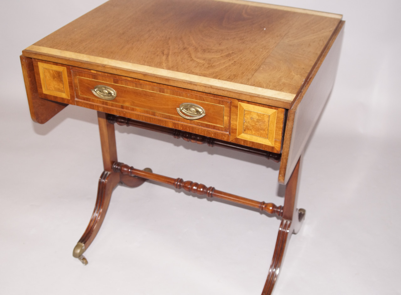 Appraisal: A reproduction mahogany Regency style sofa table of small proportions