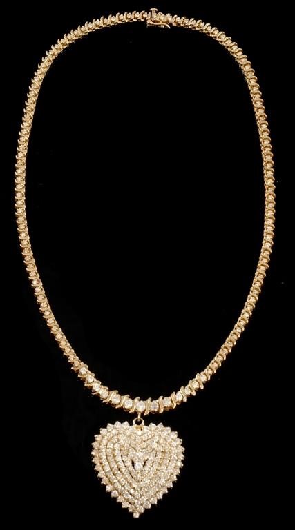 Appraisal: k yellow gold heart necklace contains round brilliant cut diamonds