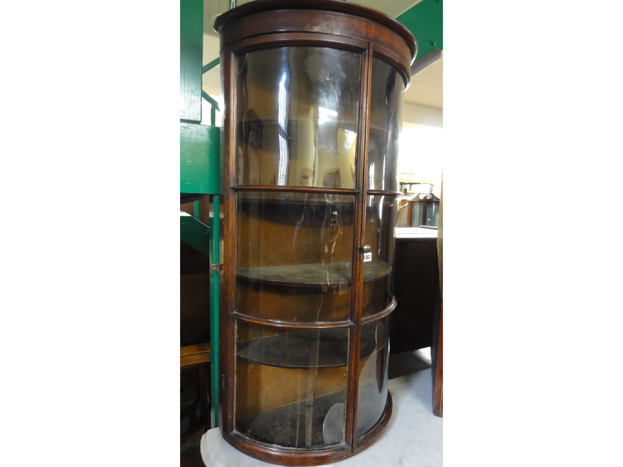 Appraisal: A th century mahogany demi-lune hanging display cabinet enclosed by