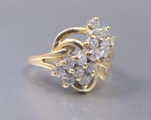 Appraisal: DIAMOND COCKTAIL RING K yellow gold ring contains fifteen round