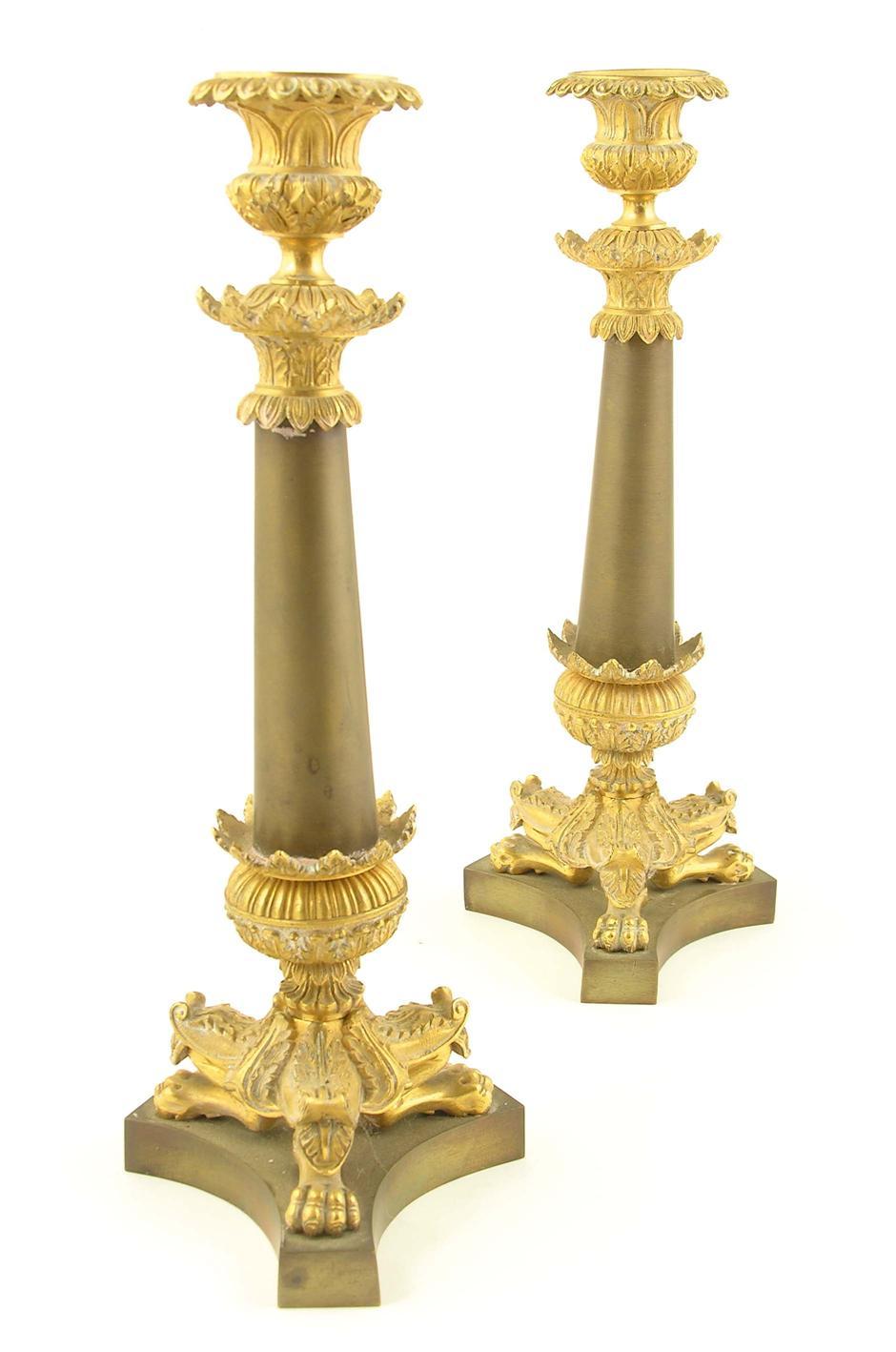 Appraisal: A pair of French gilt brass and bronzed candlesticks