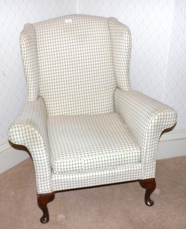 Appraisal: A winged back upholstered chair in the Georgian manner