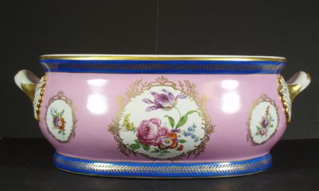 Appraisal: A large pink twin handled footbath with floral painted reserves