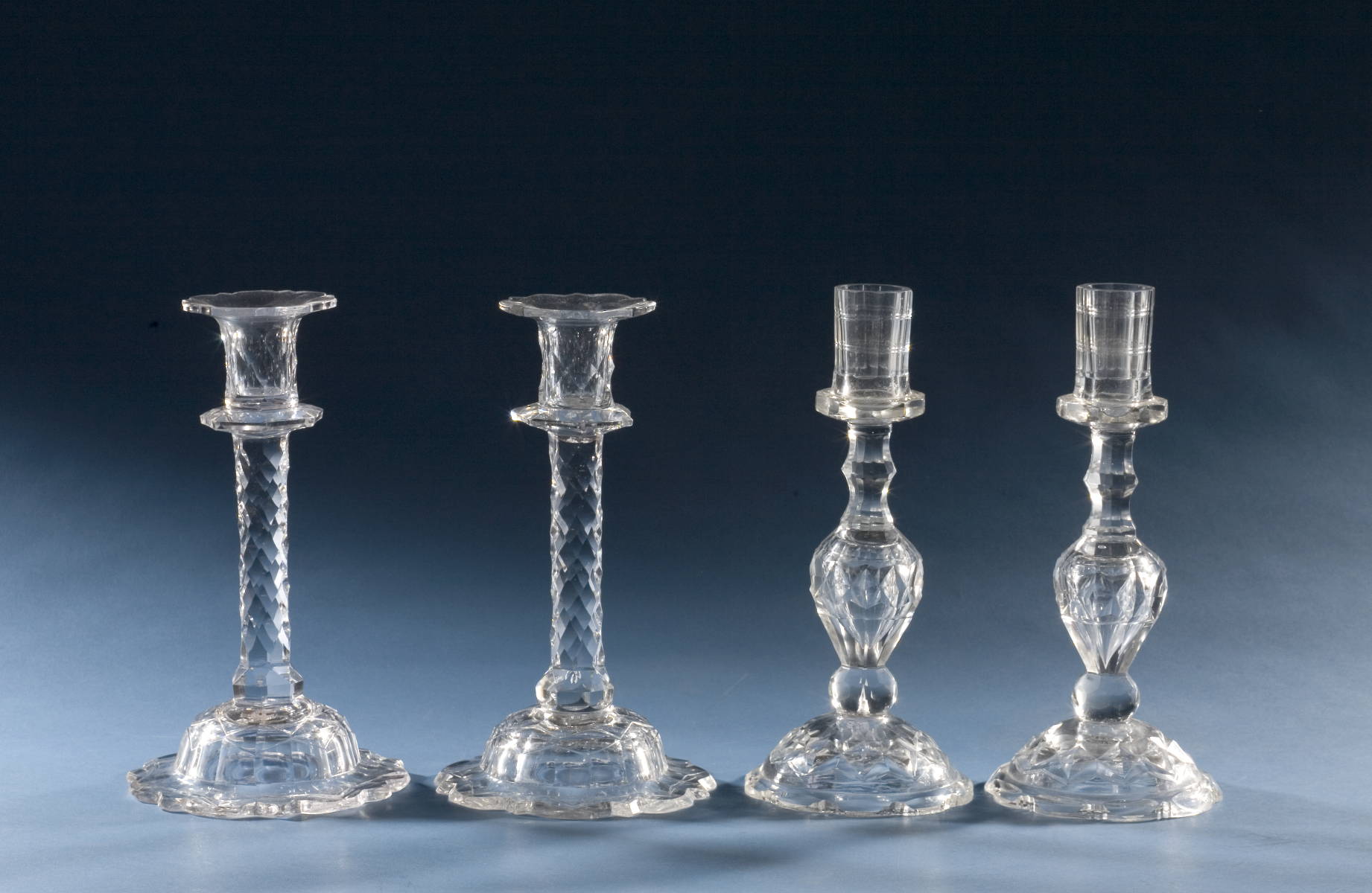 Appraisal: TWO PAIR OF SIMILAR ANGLO-IRISH CUT GLASS CANDLESTICKS Height of