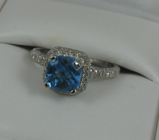 Appraisal: BLUE TOPAZ DIAMOND AND FOURTEEN KARAT GOLD RING centering a