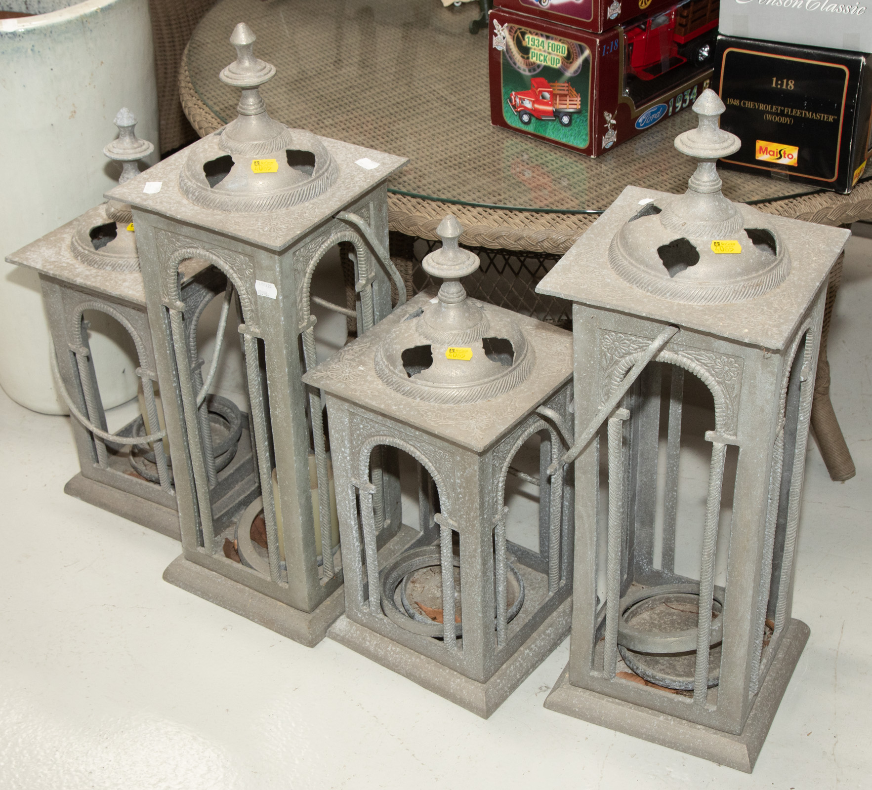 Appraisal: FOUR LARGE METAL DECORATIVE CANDLE LANTERNS Modern