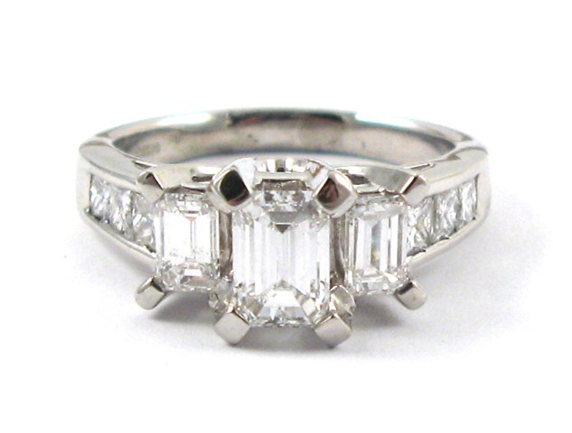 Appraisal: DIAMOND AND PLATINUM RING set with three emerald-cut diamonds together