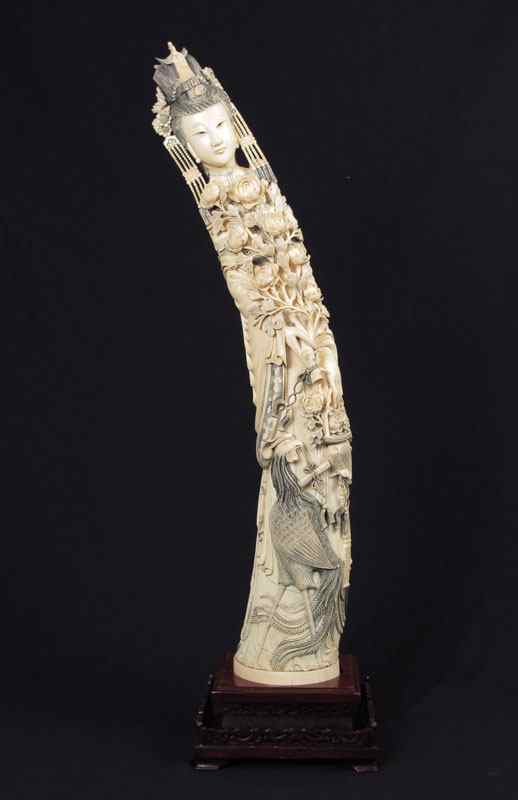 Appraisal: MONUMENTAL CARVED IVORY FIGURAL WOMAN Profusely carved from top to