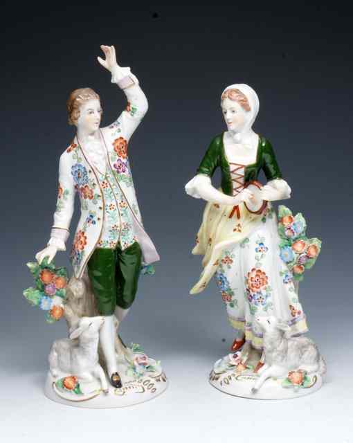 Appraisal: A PAIR OF GERMAN PORCELAIN FIGURES of a lady and