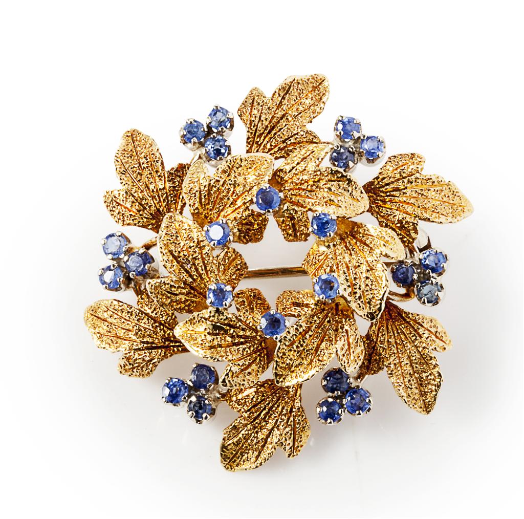 Appraisal: An ct gold and sapphire set brooch of foliate design