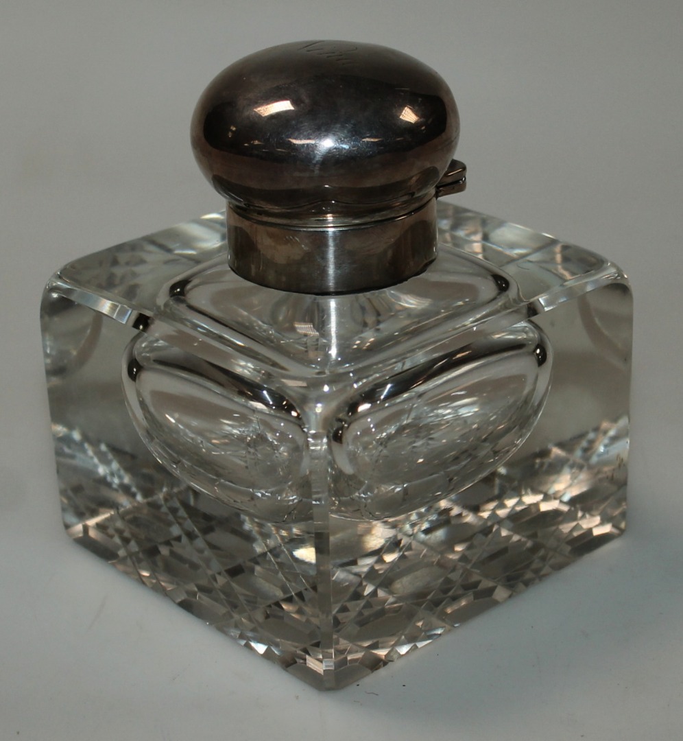 Appraisal: An Edwardian cut glass and silver topped inkwell with a