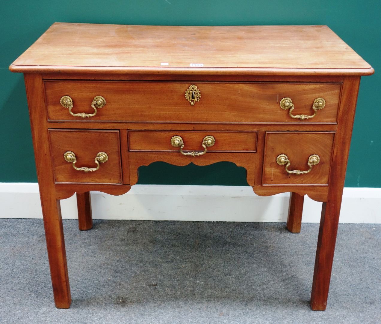 Appraisal: A George II mahogany four drawer lowboy on square supports