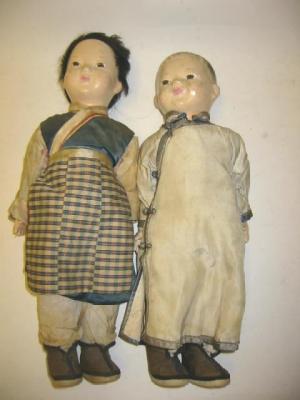 Appraisal: A pair of composition Oriental boy and girl dolls with