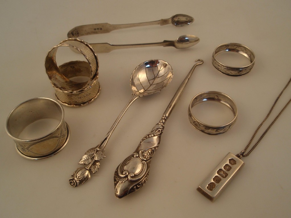 Appraisal: Four silver napkin rings a pair of thC silver sugar