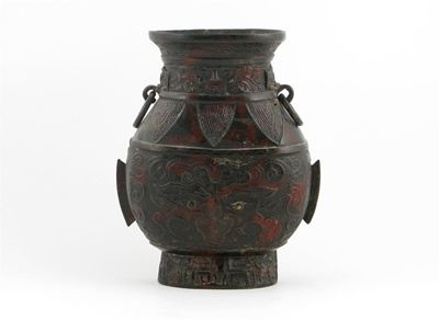 Appraisal: A Chinese bronze archaic style vase with loose ring handles