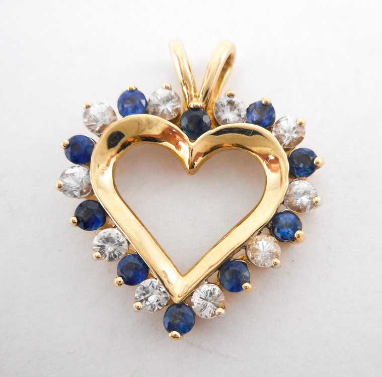 Appraisal: BLUE AND WHITE SAPPHIRE HEART PENDANT The k yellow gold