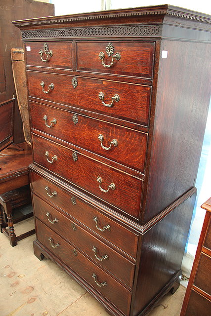 Appraisal: A GEORGE III OAK TALLBOY with blind fretwork decoration to