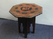 Appraisal: An octagonal demountable table with sgraffito decoration overall through black