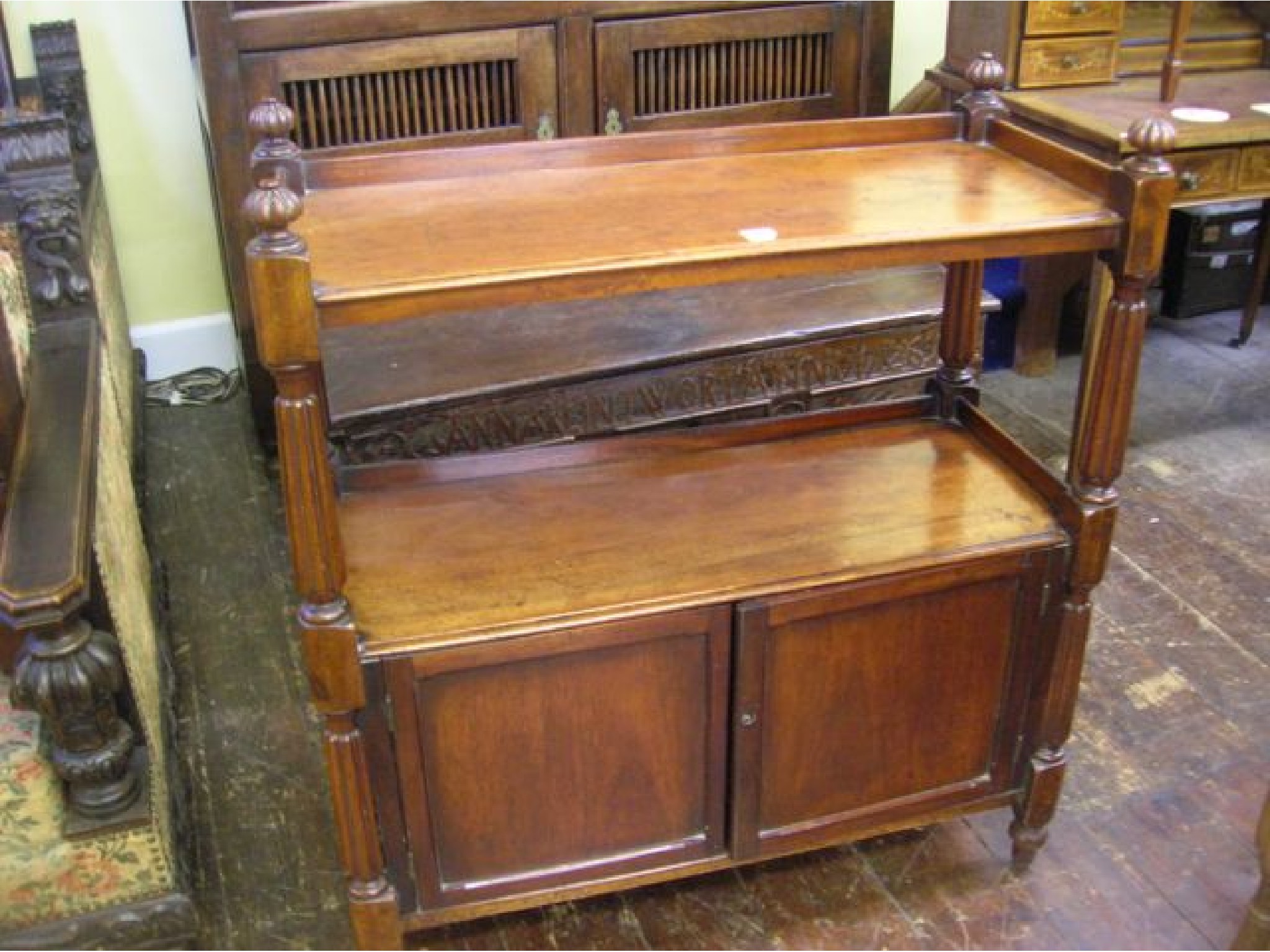 Appraisal: A small Victorian mahogany buffet the lower section enclosed by