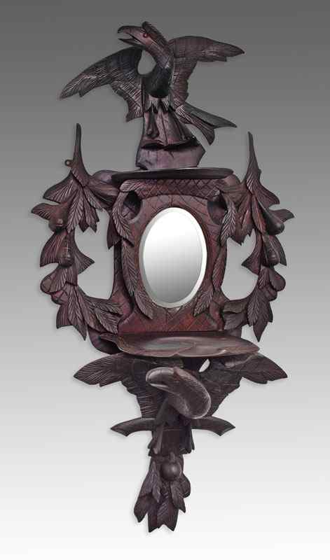 Appraisal: BLACK FOREST CARVED EAGLE WALL MIRROR Early th century naive