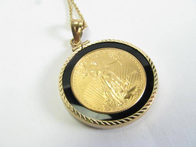 Appraisal: A K yellow gold ounce American Eagle coin surrounded by