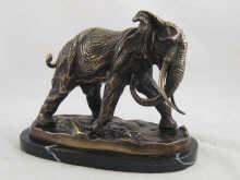 Appraisal: A large bronze model of a charging elephant on black