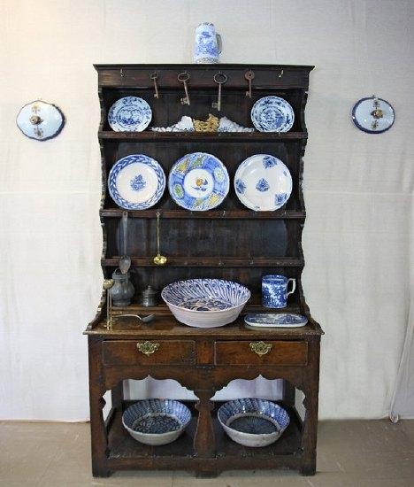 Appraisal: A small oak Welsh dresser circa the three-shelf rack on